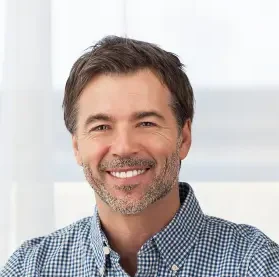 portrait smiling middle aged bearded man desk happy my client satisfied 133418672 e1752095259484 1
